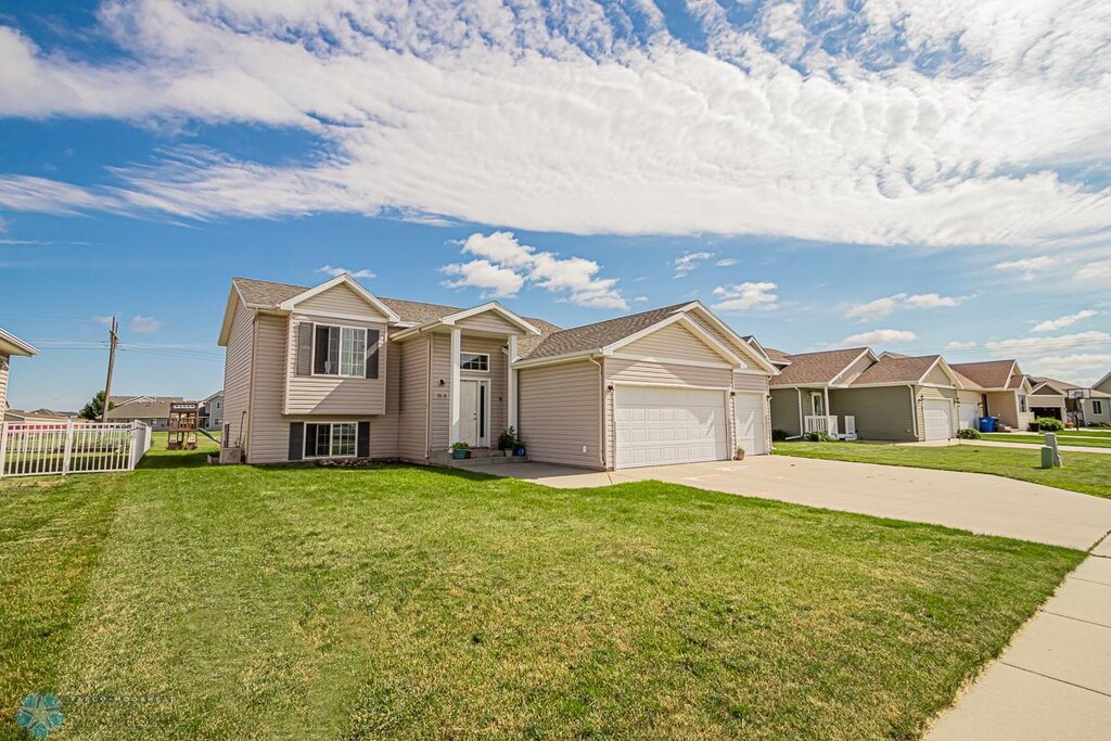 view of front of property with a front lawn and a garage