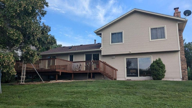 rear view of house featuring a deck and a lawn