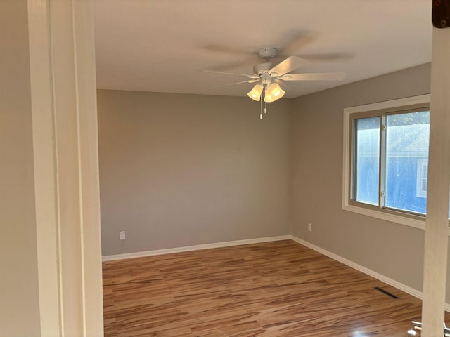 empty room featuring ceiling fan and light wood-type flooring