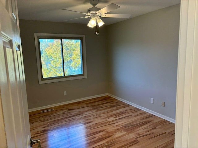 spare room featuring light hardwood / wood-style flooring and ceiling fan