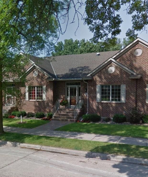 ranch-style home featuring a front yard