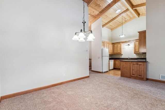 kitchen with pendant lighting, high vaulted ceiling, light colored carpet, white appliances, and beam ceiling