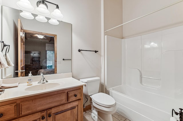 full bathroom with tile patterned flooring, vanity,  shower combination, and toilet