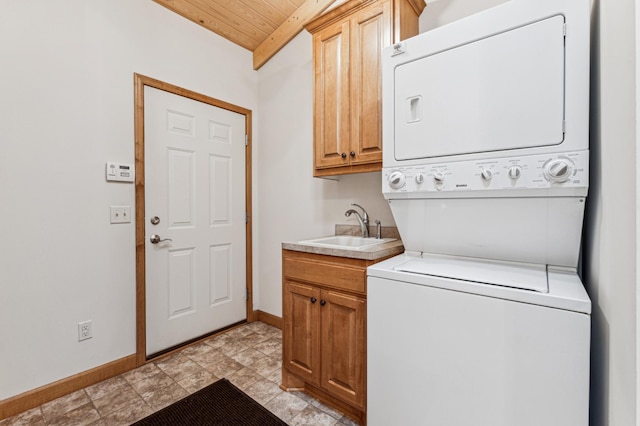 washroom with sink, wood ceiling, cabinets, and stacked washer and clothes dryer