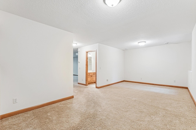 carpeted empty room with a textured ceiling