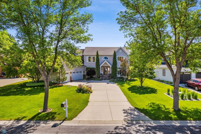 view of front facade featuring a garage and a front lawn