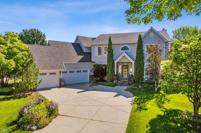 view of front of home with a garage and a front yard