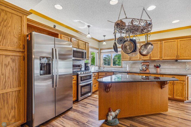 kitchen featuring appliances with stainless steel finishes, decorative backsplash, and light hardwood / wood-style floors