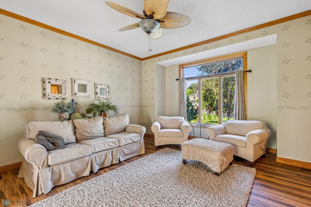 living room featuring ceiling fan, ornamental molding, and hardwood / wood-style flooring