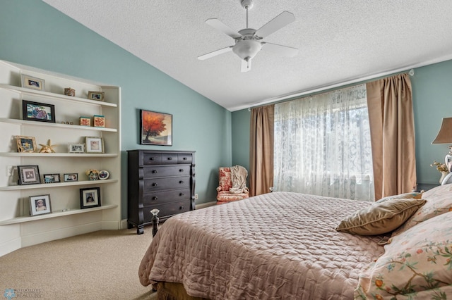 carpeted bedroom featuring a textured ceiling, lofted ceiling, and ceiling fan