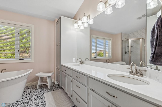 bathroom featuring lofted ceiling, tile patterned floors, dual vanity, and shower with separate bathtub