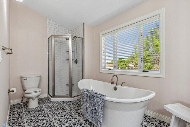 bathroom featuring lofted ceiling, separate shower and tub, tile patterned flooring, and toilet