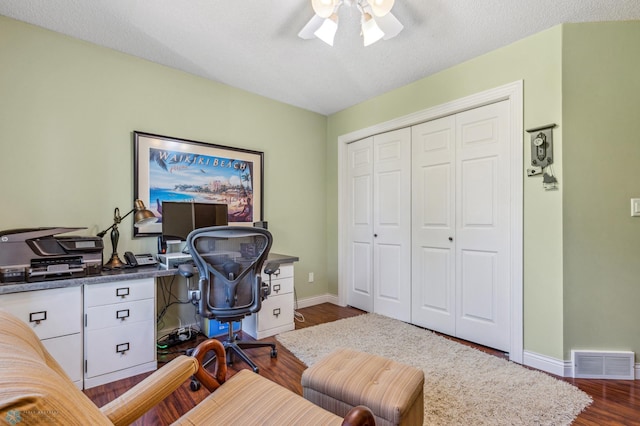 office with ceiling fan, wood-type flooring, and a textured ceiling