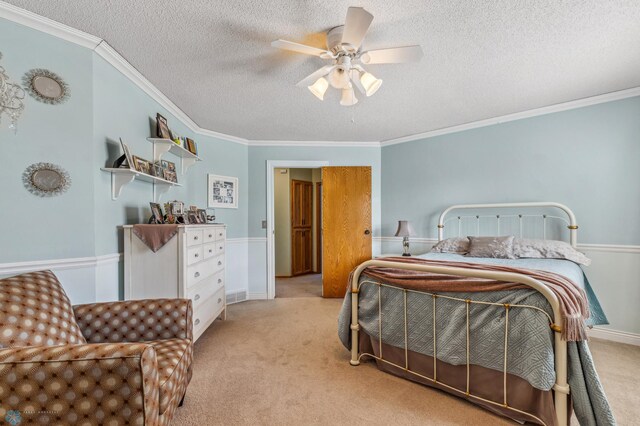 bedroom with ceiling fan, light colored carpet, and crown molding