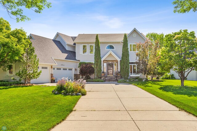 view of front of home featuring a garage and a front yard