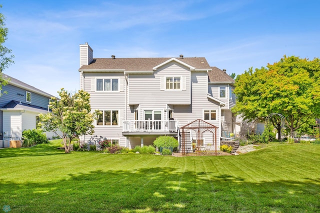 back of house with a lawn