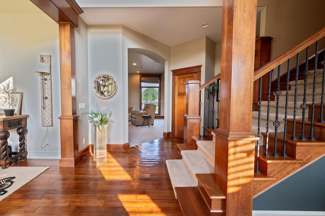 entryway with dark hardwood / wood-style floors and decorative columns