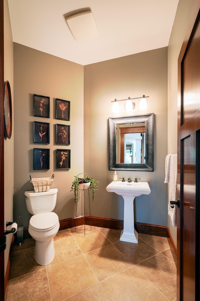 bathroom featuring sink, tile patterned floors, and toilet