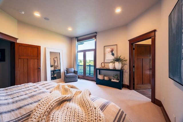 bedroom featuring light carpet and access to outside