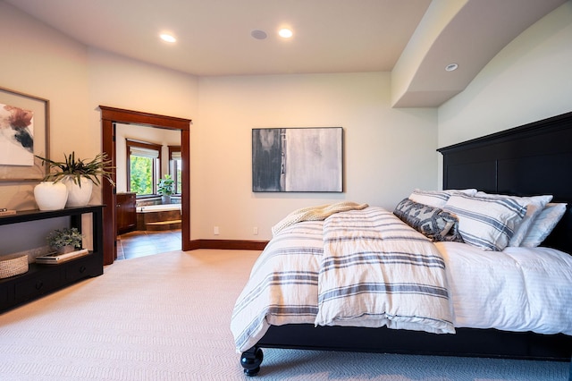 bedroom with ensuite bathroom and carpet