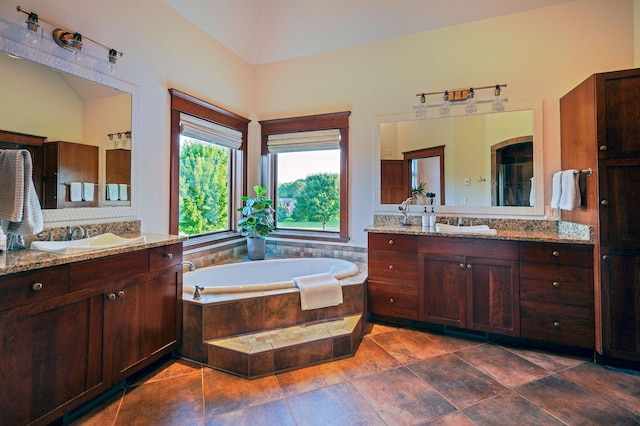 bathroom with vanity and tiled bath