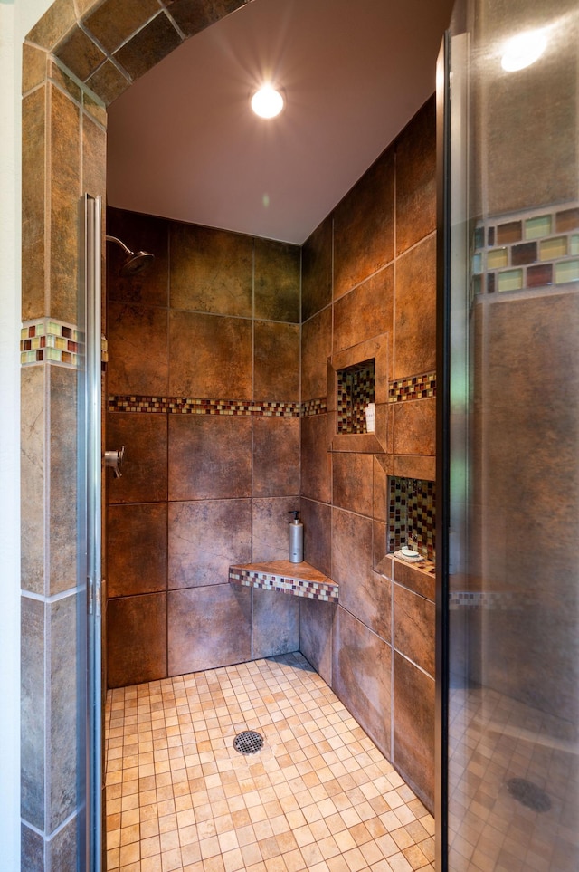 bathroom with a tile shower