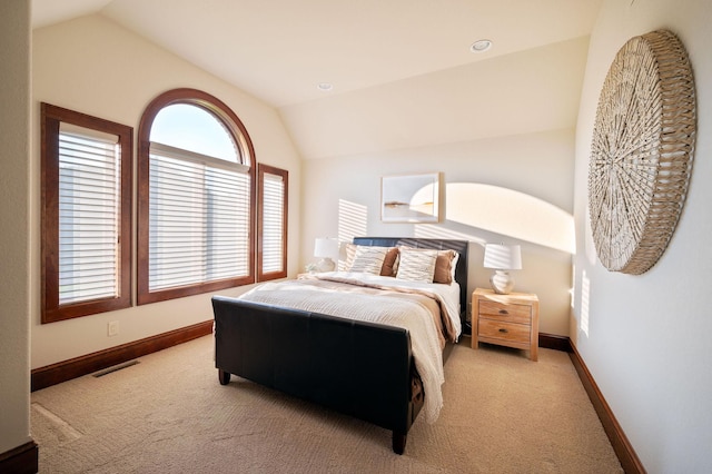 bedroom featuring light carpet and lofted ceiling