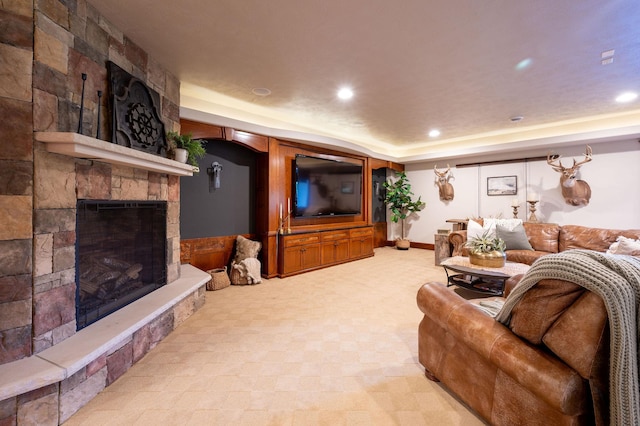 living room with a fireplace and a raised ceiling