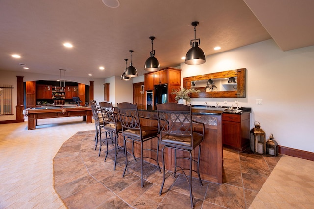 kitchen with billiards, a kitchen breakfast bar, and hanging light fixtures