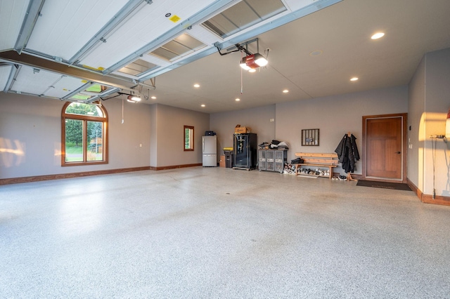 garage with a garage door opener and refrigerator