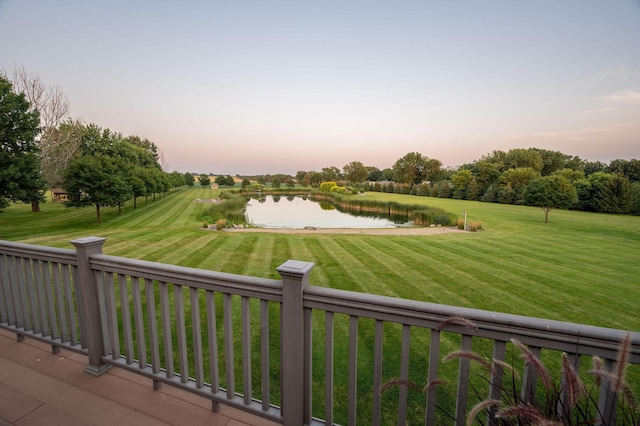 view of property's community featuring a water view and a lawn