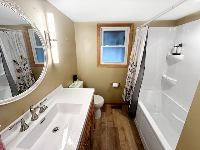 full bathroom featuring shower / bathtub combination with curtain, toilet, vanity, and hardwood / wood-style flooring