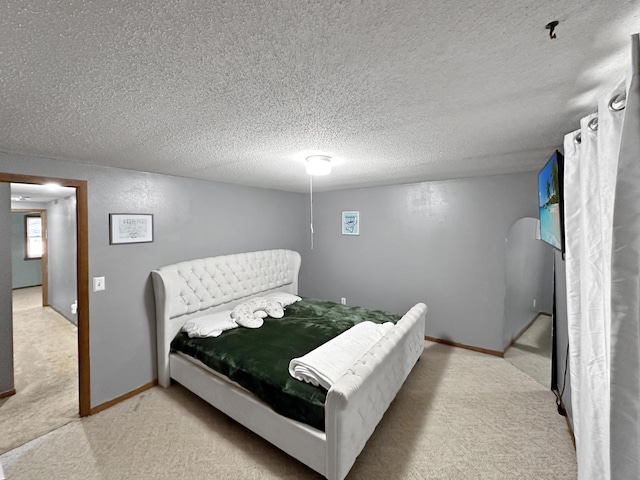 carpeted bedroom with a textured ceiling