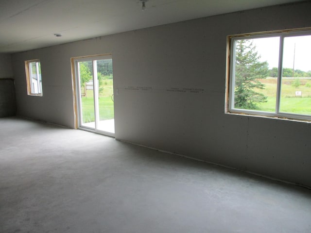 spare room with concrete floors and plenty of natural light