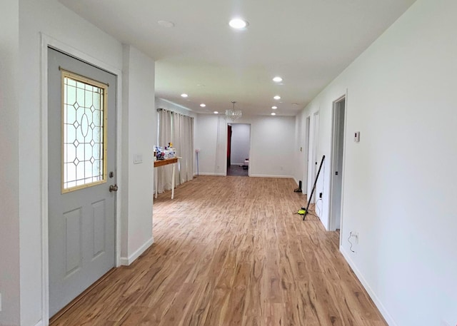 foyer entrance featuring light wood finished floors, recessed lighting, and baseboards