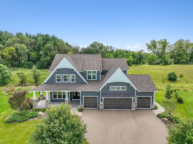 view of front of house with a garage and a front lawn