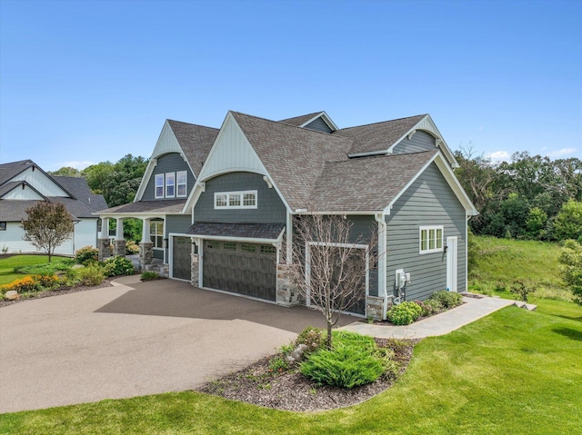 view of front of house with a front yard and a garage