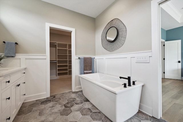 bathroom featuring vanity and a bath