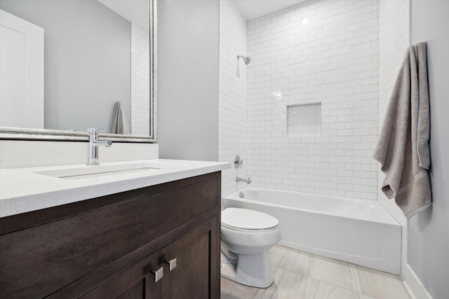 full bathroom featuring toilet, tiled shower / bath combo, and vanity