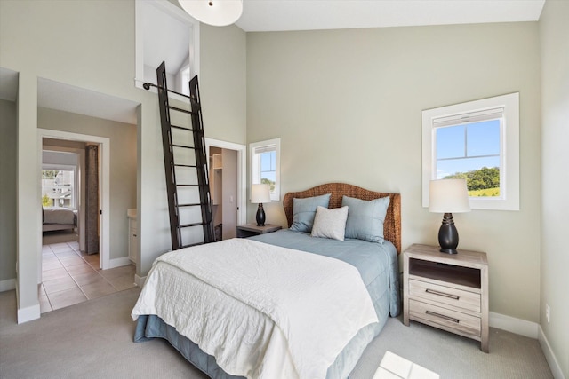 carpeted bedroom with high vaulted ceiling and multiple windows