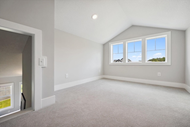 interior space with lofted ceiling and carpet floors