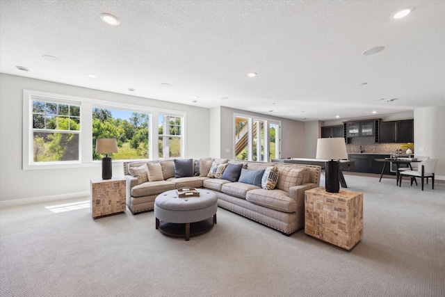 living room featuring light carpet and a textured ceiling