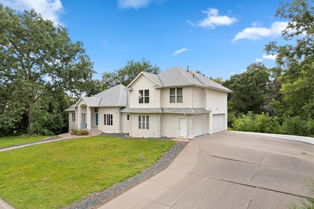 view of front of home with a front lawn and a garage