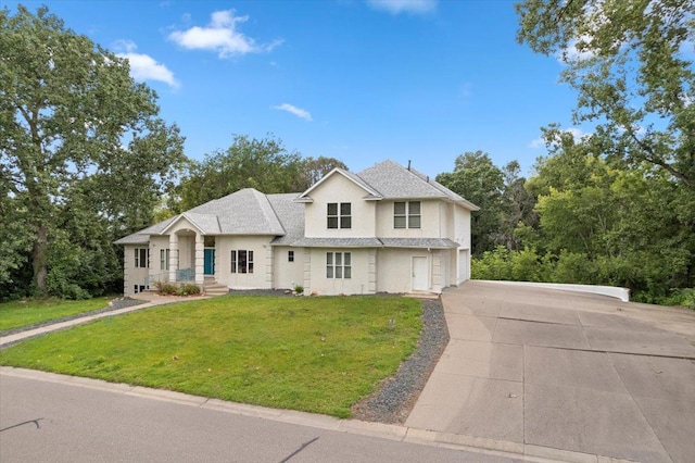 view of front of home with a garage and a front yard