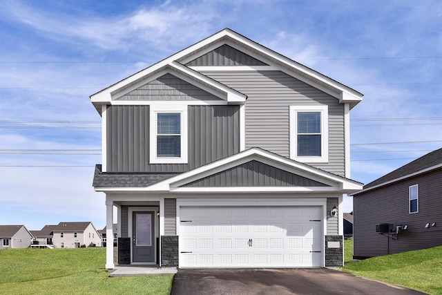 view of front of house featuring a garage and a front lawn