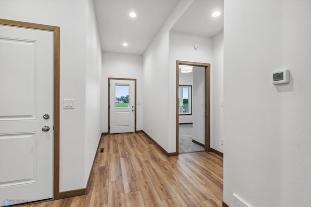 entryway featuring light wood-style floors, baseboards, and recessed lighting
