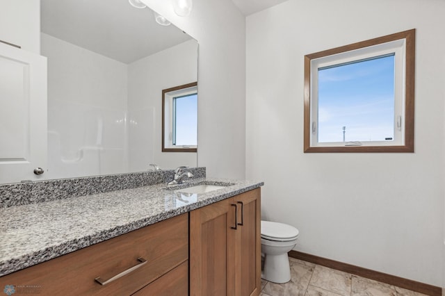 bathroom featuring baseboards, vanity, toilet, and marble finish floor