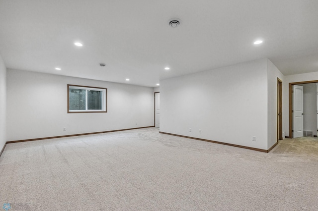 spare room with recessed lighting, baseboards, and light carpet