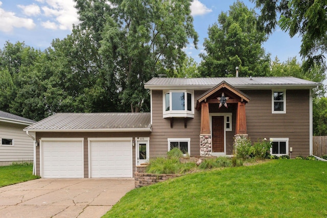 bi-level home with a garage and a front lawn