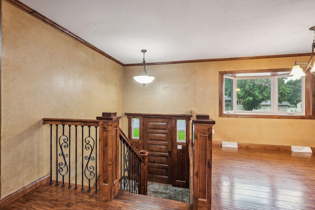 stairway featuring crown molding and hardwood / wood-style floors